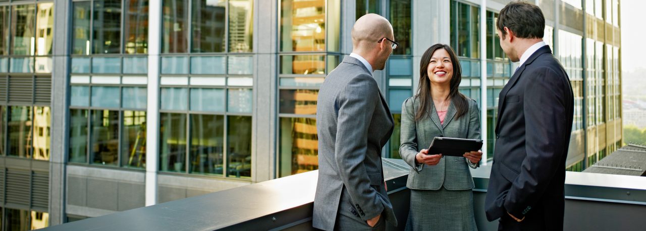 three people in an office balcony 