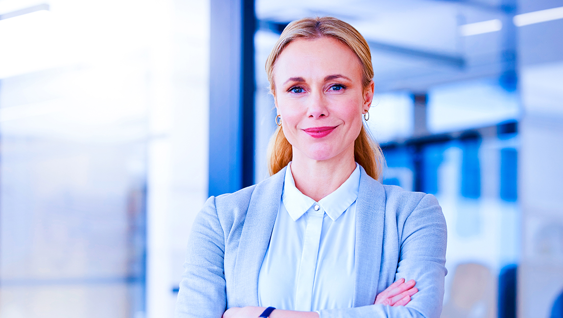 Business woman smiling with her arms folded