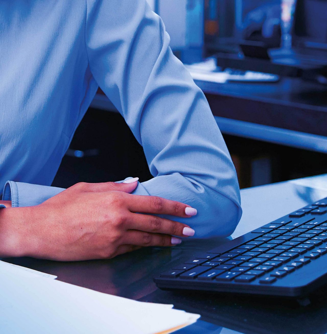 Continuation of business woman smiling at her desk
