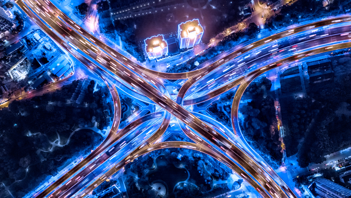 Aerial night view of busy city intersection lit up