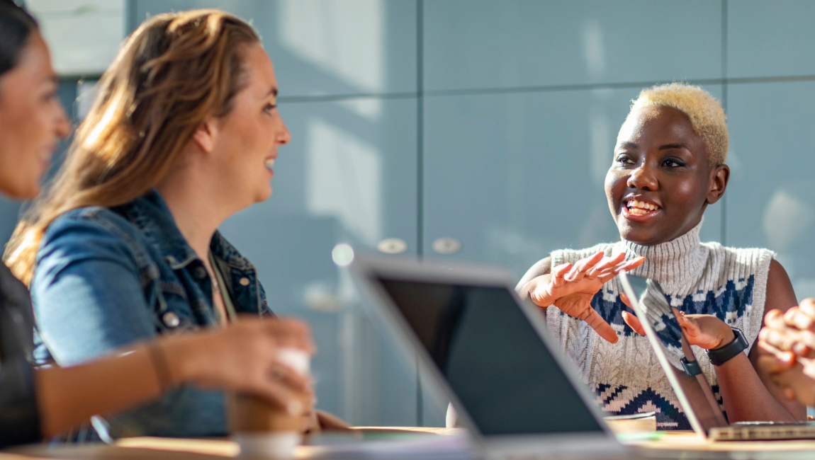 Young colleagues speaking cheerfully during meeting