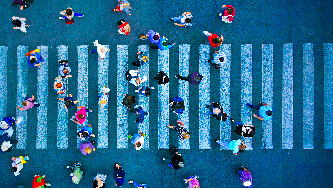 Aerial view of people walking across a crosswalk