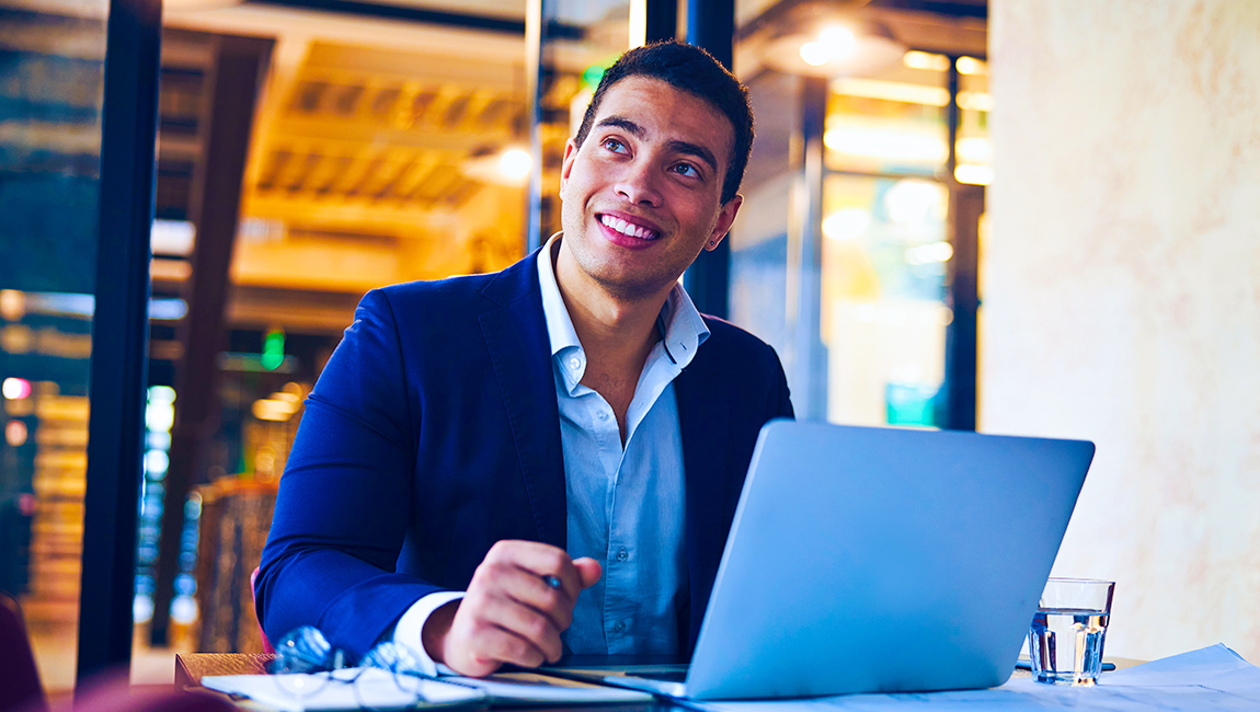 Man working at table with laptop