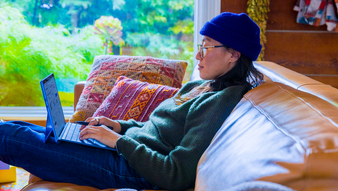 Woman browsing tablet on couch