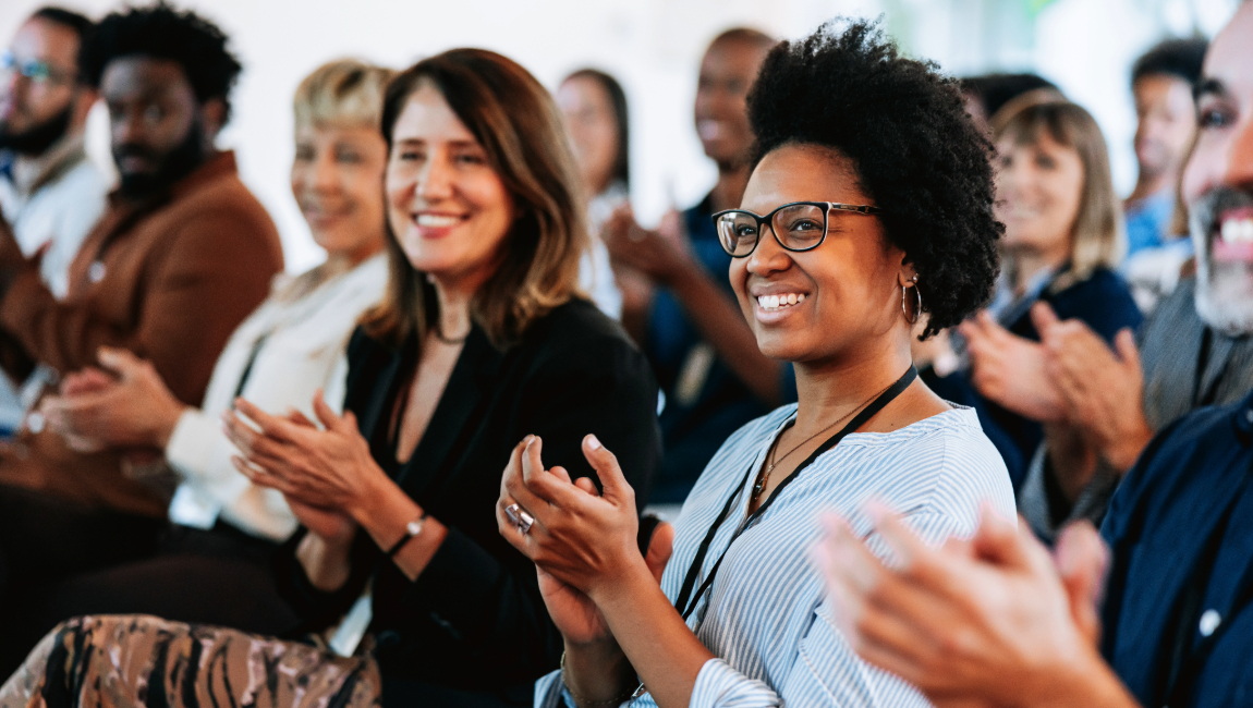 Work colleagues smiling and clapping