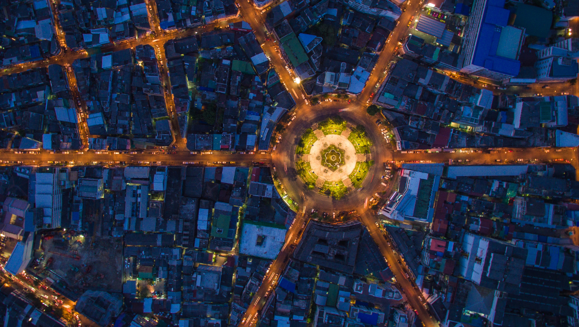 Aerial view of circular road at night in busy city