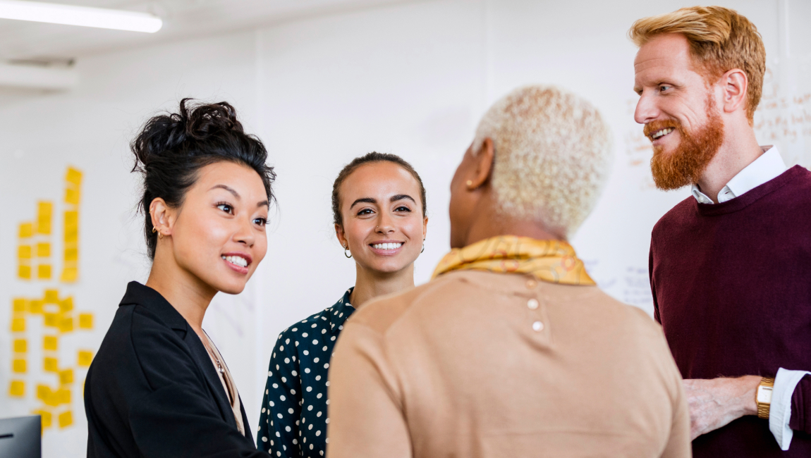 A group of colleagues standing up and chatting